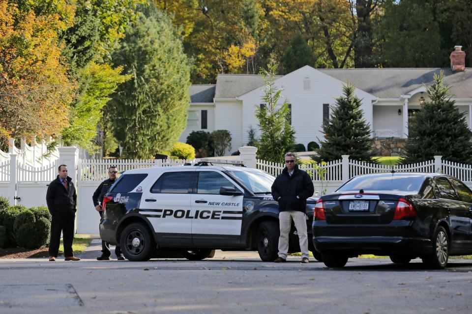 Police officers stand in front of property owned by Hillary and Bill Clinton in Chappaqua, N.Y., on Oct. 24, 2018.