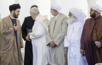 Pope Francis,, second from left, is seen of at the end of an interreligious meeting near the archaeological area of the Sumerian city-state of Ur, 20 kilometers south-west of Nasiriyah, Iraq, Saturday, March 6, 2021. Ur is considered the traditional birthplace of Abraham, the prophet common to Muslims, Christians and Jews.Francis traveled to the southern ruins of Ur on Saturday to reinforce his message of interreligious tolerance and fraternity during the first-ever papal visit to Iraq, a country riven by religious and ethnic divisions. (AP Photo/Andrew Medichini)