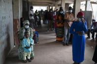 People wait to cast their ballot for Gambia's presidential elections, in Banjul, Gambia, Saturday, Dec. 4, 2021. Lines of voters formed outside polling stations in Gambia’s capital as the nation holds a presidential election. The election on Saturday is the first in decades without former dictator Yahya Jammeh as a candidate. (AP Photo/Leo Correa)