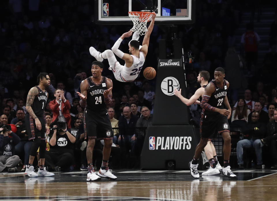 Brooklyn Nets' Rondae Hollis-Jefferson (24), Caris LeVert (22) and D'Angelo Russell (1) react to a dunk by Philadelphia 76ers' Ben Simmons (25) during the second half in Game 3 of a first-round NBA basketball playoff series Thursday, April 18, 2019, in New York. The 76ers won 131-115. (AP Photo/Frank Franklin II)