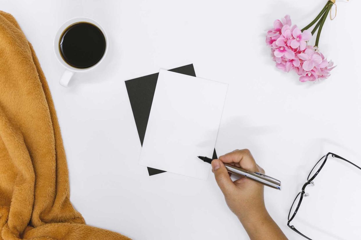 Top View of Woman Hand Writing on Stationary Card