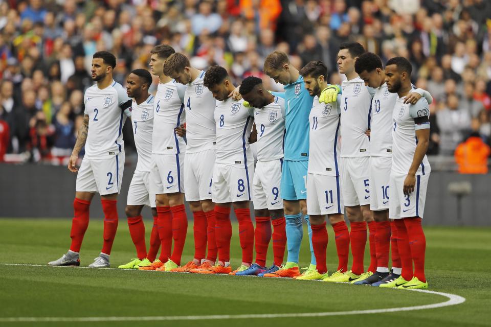 England's team hold a minute of silence for the victims of the Westminster attack in central London on Wednesday prior the World Cup Group F qualifying soccer match between England and Lithuania at the Wembley Stadium in London, Great Britain, Sunday, March 26, 2017. (AP Photo/Frank Augstein)