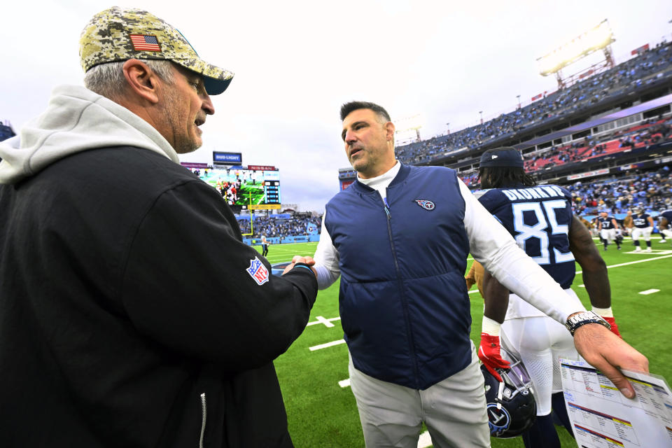 Carolina Panthers head coach Frank Reich, left, congratulates Tennessee Titans head coach Mike Vrabel after an NFL football game Sunday, Nov. 26, 2023, in Nashville, Tenn. The Titans won 17-10. (AP Photo/John Amis)