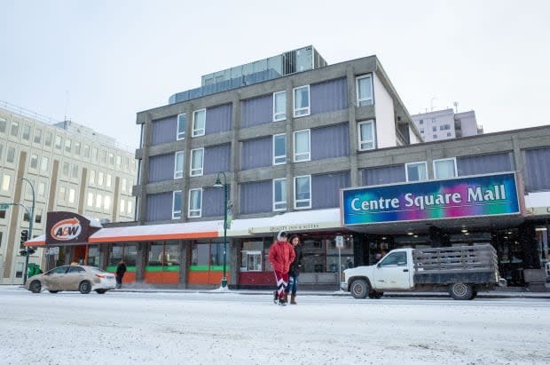 Two people cross Franklin Avenue in downtown Yellowknife on Nov.13, 2019. The intersection at nearby 49 Street and 51 Avenue will be closed to all traffic on Wednesday, Feb. 24 as the city completes repairs to a water break. (Walter Strong/CBC - image credit)