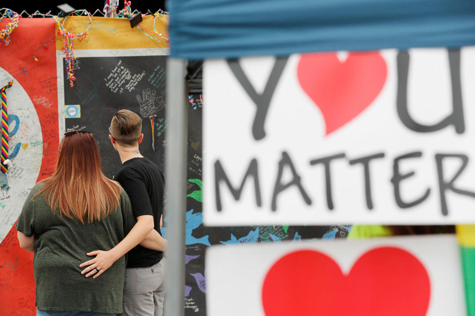 <p>Liz Lockwood (R) embraces Leann Ferguson outside the Pulse nightclub on the one year anniversary of the shooting, in Orlando, Florida, U.S., June 12, 2017. (REUTERS/Scott Audette) </p>