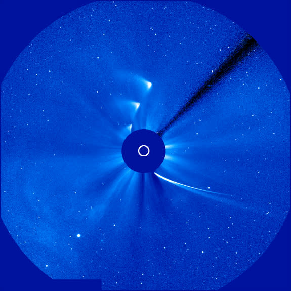 This time-lapse image shows Comet ISON approaching and leaving during its slingshot around the sun – represented by the white circle -- on Nov. 28, 2013. The ISON images clearly outline the curve of the comet's orbit path. The images were captu