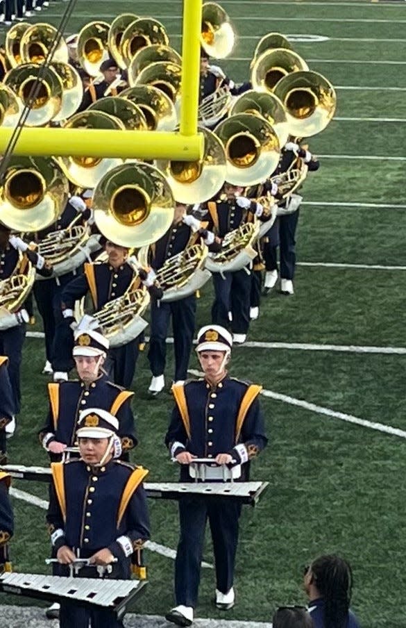 Luke Foster is shown marching during a football game halftime performance at the University of Notre Dame.