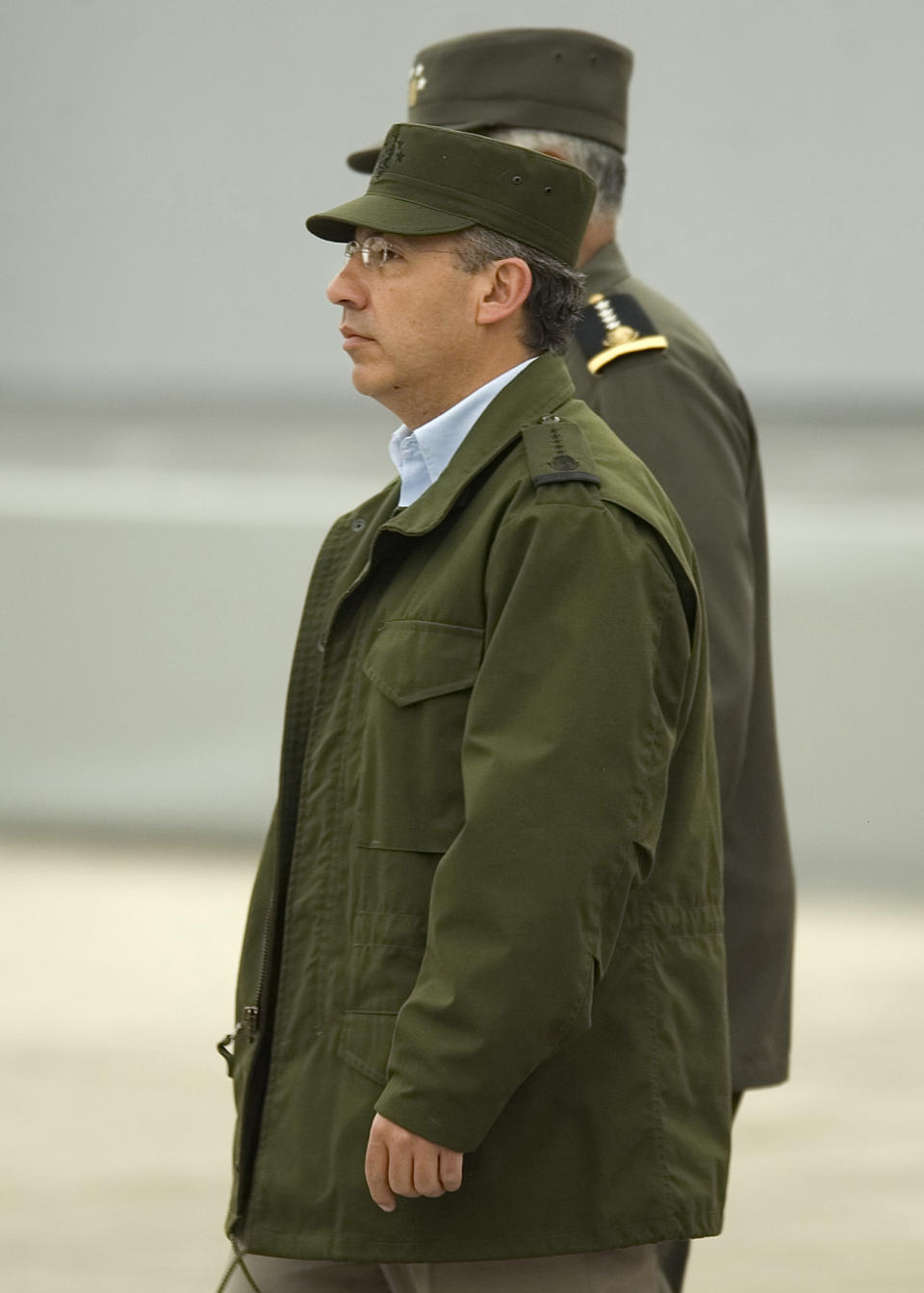 FILE- In this Wednesday Jan. 3, 2006 file photo, Mexico's President Felipe Calderon arrives wearing a military cap and jacket, at the base of the 43th militar zone to meet with federal forces involved in ongoing anti-crime operations in Apatzingan, Mexico. Mexicans hoped that their country would take a new course under Vicente Fox's center-right National Action Party, or PAN, but despite a more open economy and a bigger middle class, Mexico is torn by drug trafficking violence after a dozen years under the PAN's leadership, first under Fox and then under current President Felipe Calderon, who barely squeaked by in contested 2006 elections. (AP Photo/Guillermo Arias, File)