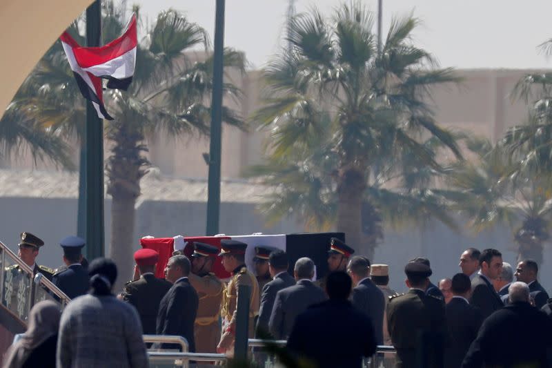 Guards carry the coffin of former Egyptian President Hosni Mubarak as they arrive at Field Marshal Mohammed Hussein Tantawi Mosque, during his funeral east of Cairo