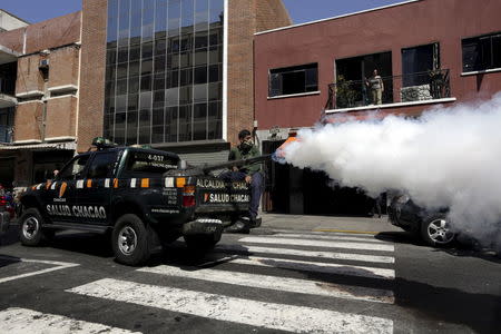 A pick-up truck from the Department of Health of the municipality of Chacao drives as it fumigates the neighborhood during a fumigation campaign to help control the spread of the mosquito-borne Zika virus in Caracas, February 2, 2016. REUTERS/Marco Bello