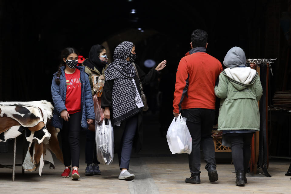 Mask-clad shoppers walk at Tehran's Grand Bazaar, ahead of the Persian New Year, or Nowruz, meaning "New Day" in Iran, Monday, March 15, 2021. (AP Photo/Vahid Salemi)