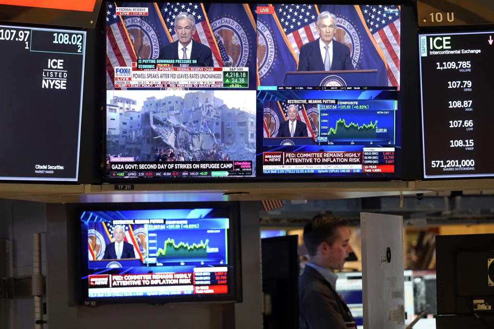 File - Federal Reserve Chairman Jerome Powell appears on several television screens on the floor of the New York Stock Exchange, Nov. 1, 2023. The global economy, which has proved surprisingly resilient this year, is expected to falter next year under the strain of wars, still-elevated inflation and continued high interest rates. (AP Photo/Richard Drew, File)