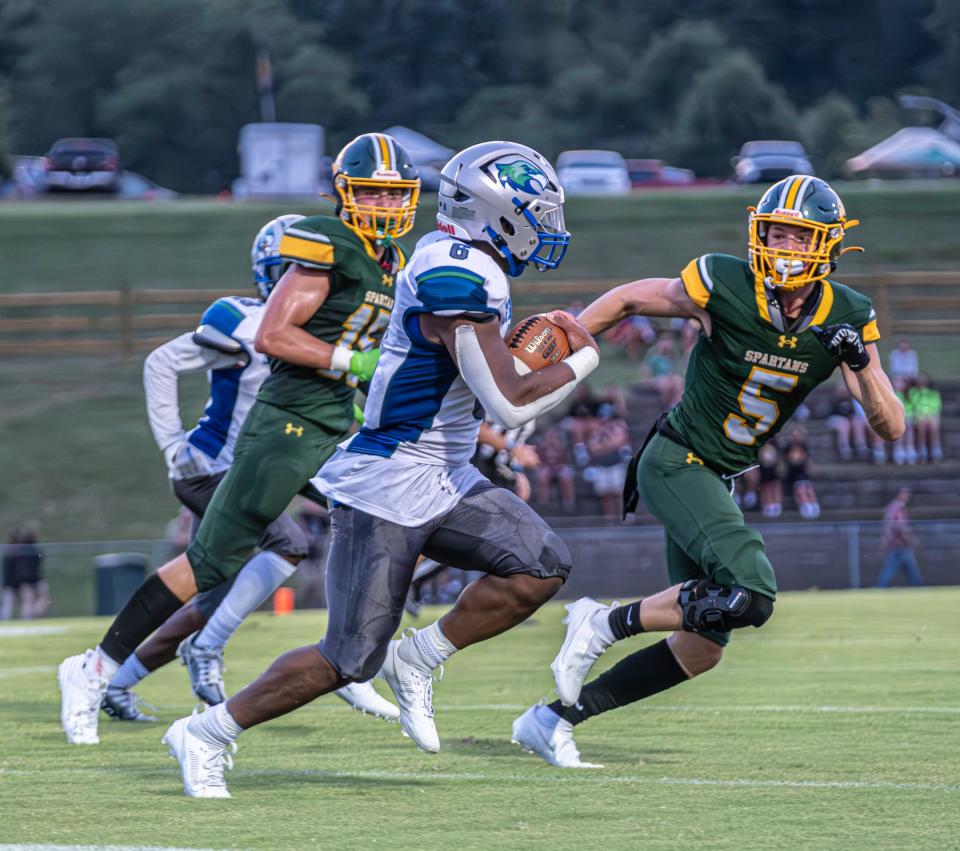 St. Georges running back Camron Montgomery tries to outrun Saint Mark's Logan Klein (left) and Liam MacDonald on Sept. 8. The Hawks rallied for a 20-9 victory, and all three of our experts believe St. Georges will win a close one over Hodgson on Saturday.