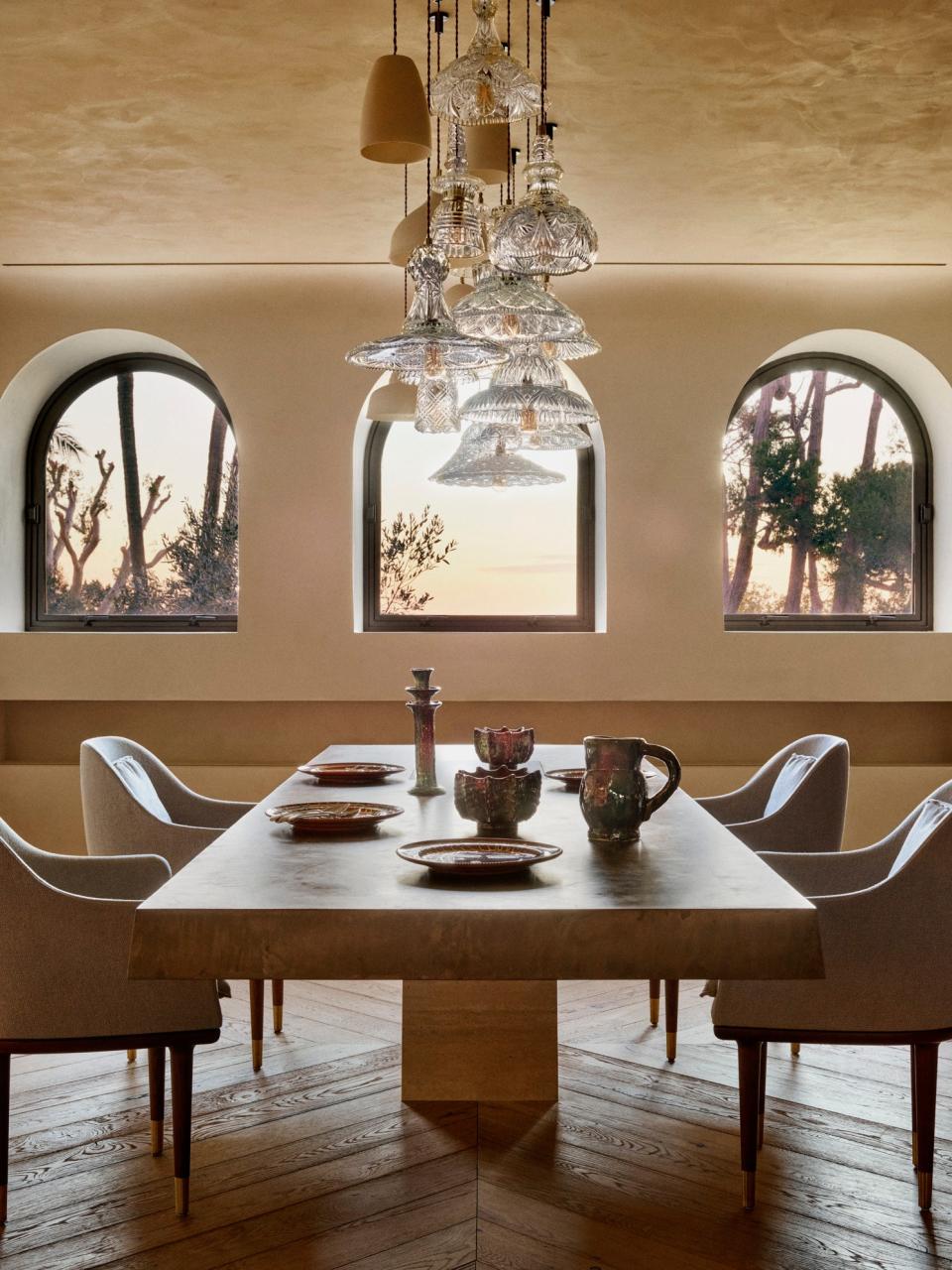 In the dining room, the large ceiling suspension is a unique piece by Les Penates. The ceramic plates are by Nicola Fasano of Fasano Ceramiche while the vintage ceramic jugs and candlestick are from Morocco.