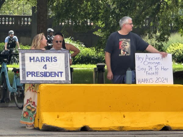  Supporters of Vice President Kamala Harris, the likely Democratic presidential nominee, display signs across the street from the Hilton Chicago, where GOP presidential nominee Donald Trump appeared at the National Association of Black Journalists convention Wednesday. Photo by William J. Ford