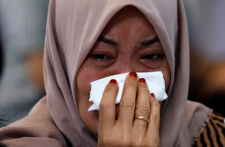 A woman cries on the deck of Indonesia Navy ship KRI Banjarmasin as families and colleagues of passengers and crew of Lion Air flight JT610 visit the site of the crash to pay their tribute, at the north coast of Karawang, Indonesia, November 6, 2018. REUTERS/Beawiharta