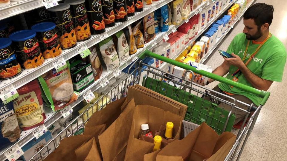 An Instacart shopper fills an order for a customer at Publix. The online delivery company serves most local supermarkets.