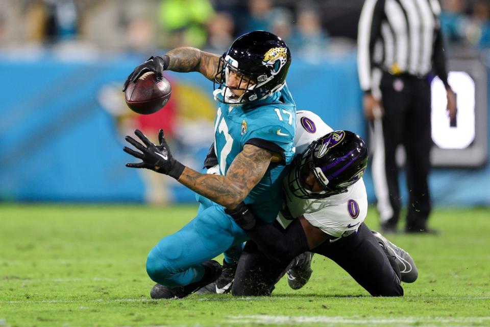 Dec 17, 2023; Jacksonville, Florida, USA; Jacksonville Jaguars tight end <a class="link " href="https://sports.yahoo.com/nfl/players/30136" data-i13n="sec:content-canvas;subsec:anchor_text;elm:context_link" data-ylk="slk:Evan Engram;sec:content-canvas;subsec:anchor_text;elm:context_link;itc:0">Evan Engram</a> (17) is tackled by Baltimore Ravens linebacker Roquan Smith (0) in the second quarter at EverBank Stadium. Mandatory Credit: Nathan Ray Seebeck-USA TODAY Sports