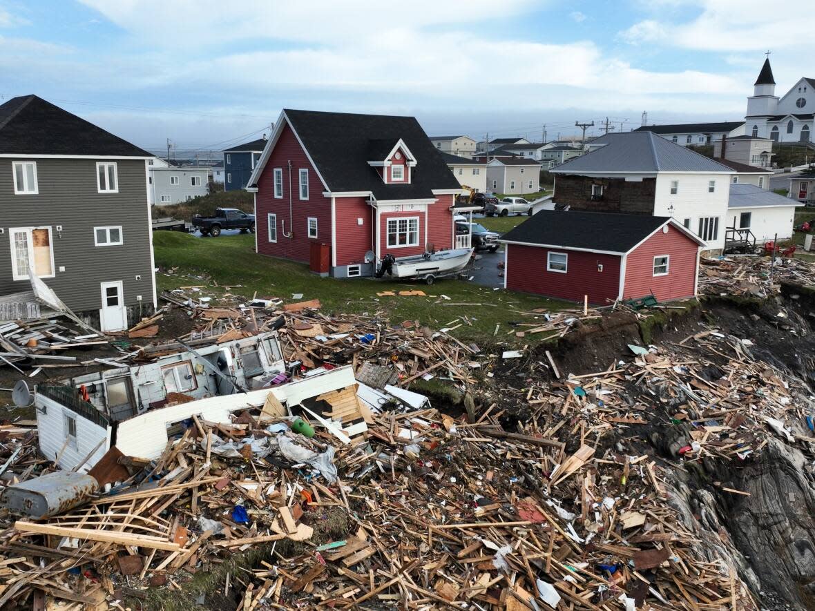 This aerial drone photo shows extensive damage to homes in Port aux Basques, N.L., on Saturday. (Yan Theoret/CBC - image credit)