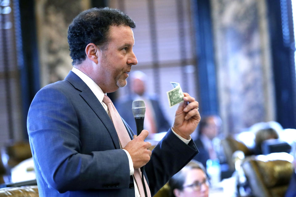 Sen. David Parker, R-Olive Branch, asks about the "In God We Trust" motto on legal tender and how it might be safeguarded for use on the new state flag as required by proposed legislation for changing Mississippi's current state flag Sunday, June 28, 2020 at the Capitol in Jackson, Miss. The bill to change the state flag passed 37-14. Both chambers of the Mississippi Legislature passed the bill to take down the state flag, which contains the Confederate battle emblem. (AP Photo/Rogelio V. Solis)