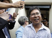 Reuters reporter Wa Lone reacts as he is freed from Insein Prison in Yangon, Myanmar, Tuesday, May 7, 2019. Two Reuters journalists who were imprisoned for breaking Myanmar's Official Secrets Act over reporting on security forces' abuses of Rohingya Muslims were pardoned and released Tuesday, the prison chief and witnesses said. (Ann Wang/Pool Photo via AP)