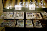 Newspapers headlining Prince Harry and Meghan’s explosive TV interview are displayed for sale outside a shop in London, Tuesday, March 9, 2021. Britain's royal family is absorbing the tremors from a sensational television interview by Prince Harry and the Duchess of Sussex, in which the couple said they encountered racist attitudes and a lack of support that drove Meghan to thoughts of suicide. (AP Photo/Frank Augstein)