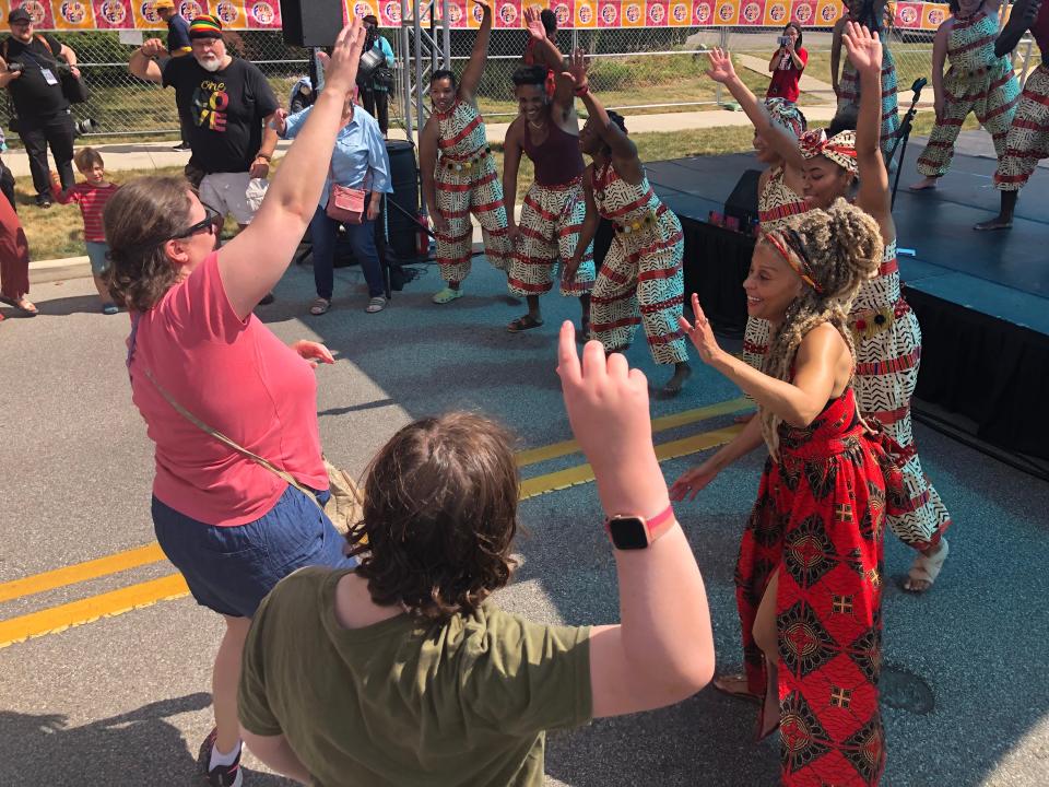 Kelly Burgèt, right, and her UZIMA! West African Dance Troupe lead the audience in a circle dance Saturday, Sept. 9, 2023, at Fusion Fest at Howard Park in South Bend.