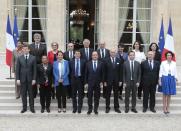 From left, front row: Economy Minister Arnaud Montebourg, Justice Minister Christiane Taubira,Environment and Energy Minister Segolene Royal, French Prime Minister Manuel Vall, French President Francois Hollande, foreign Minister Laurent Fabius, Education Minister Benoit Hamon, Finance Minister Michel Sapin and Social Affairs Marisol Touraine pose for the family picture after the first weekly cabinet meeting after municipal elections, at the Elysee Palace in Paris, Friday, April 4, 2014. Second row from the left are: Overseas Territories minister George Pau-Langevin, Agriculture Minister Stephane le Foll, State Reform and Public Service Minister Marylise Lebranchu, Interior Minister Bernard Cazeneuve, Labor Minister Francois Rebsamen, Defense Minister Jean-Yves le Drian, Women's Rights Minister Najat Vallaud-Belkacem, Culture Minister Aurelie Filippetti, and Housing Minister Sylvia Pinel. (AP Photo/Jacques Brinon)