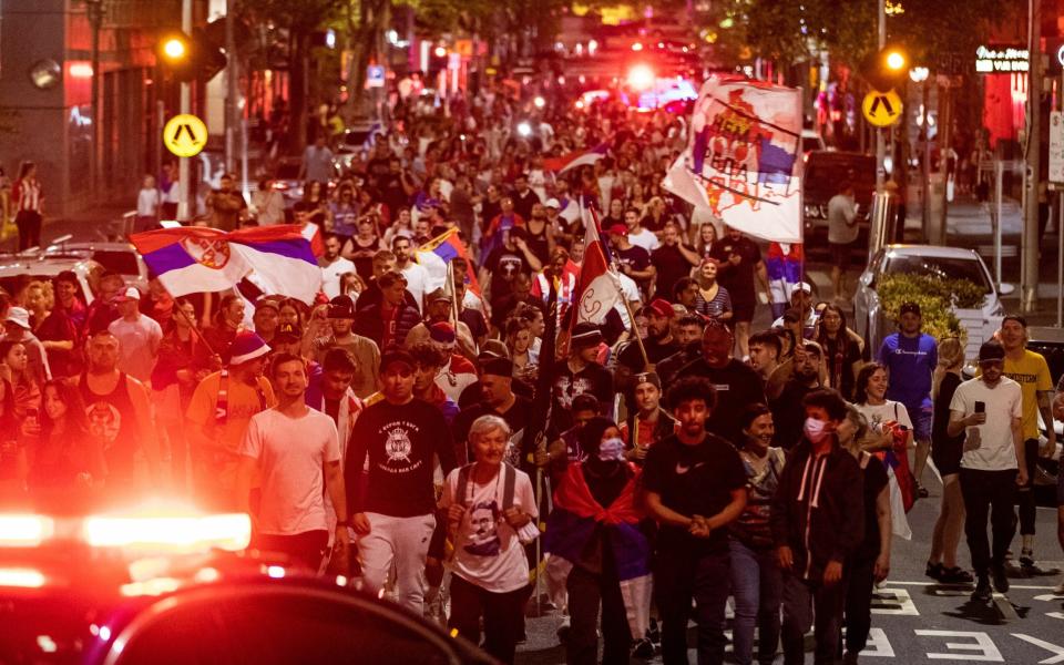 Serbian tennis fans march along Collins Street in Melbourne, Australia - Getty Images AsiaPac