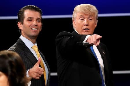 FILE PHOTO: Donald Trump Jr. (L) gives a thumbs up beside his father Republican U.S. presidential nominee Donald Trump (R) after Trump's debate against Democratic nominee Hillary Clinton at Hofstra University in Hempstead, New York, U.S. September 26, 2016. REUTERS/Mike Segar/File Photo