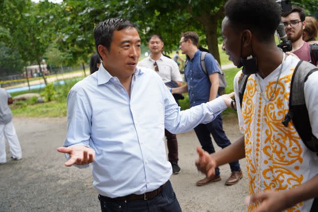 Andrew Yang talks to a voter in Manhattan's Morningside Park on Saturday. Once a frontrunner, the businessman and former presidential candidate has slid in recent polls. (Photo: Rob Kim/Getty Images)