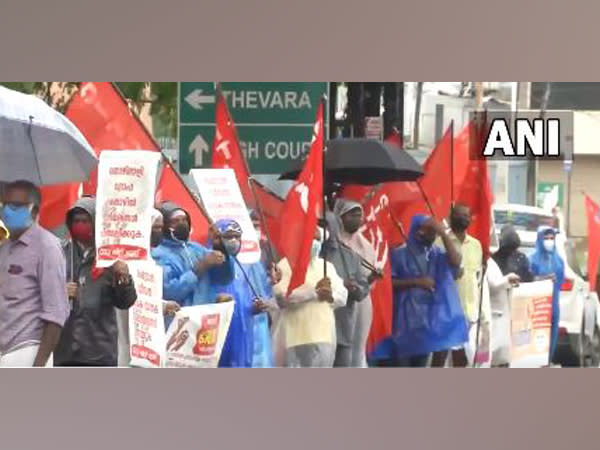 Protesters of several trade unions  form a human chain in Kochi to support the call for Bharat Bandh. (Photo/ ANI)