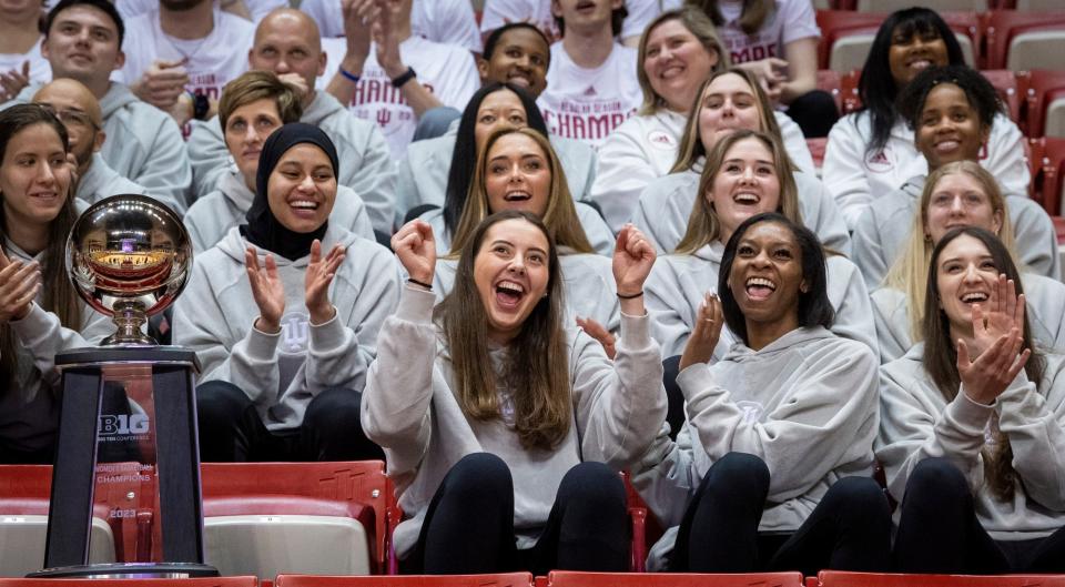 Indiana's Mackenzie Holmes, center, reacts to seeing herself in a highlight of Indiana during the broadcast of the reveal of the 2023 NCAA Women's Tournament bracket at Simon Skjodt Assembly Hall on Sunday, March 12, 2023.