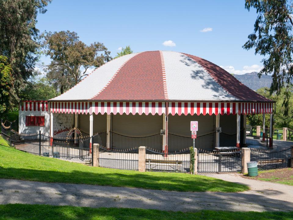 The merry-go-round at Griffith Park with tress and the sky in the background