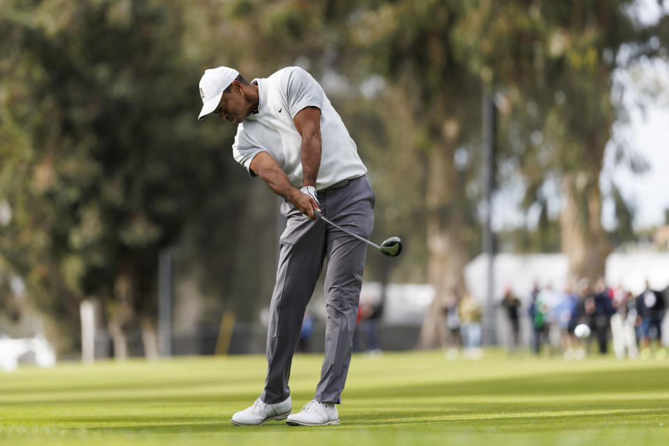 Tiger Woods hits his second shot on the 11th hole during the third round of the Genesis Invitational golf tournament at Riviera Country Club, Saturday, Feb. 18, 2023, in the Pacific Palisades area of Los Angeles. (AP Photo/Ryan Kang)
