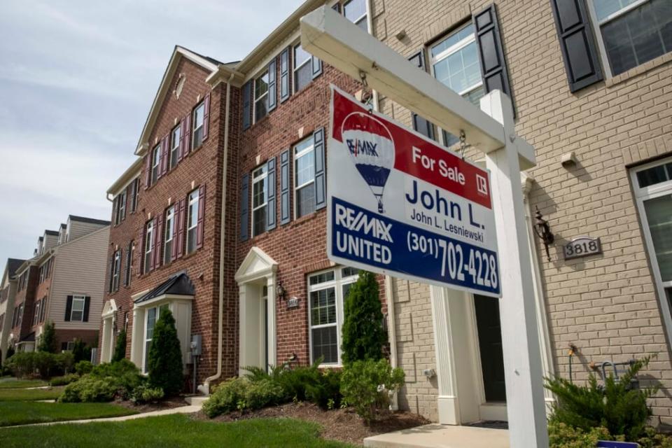 A “For Sale” sign sits in the front yard of a townhouse June 23, 2015 in Northeast Washington, DC. Purchases of new homes in the U.S. rose in May to the highest level in seven years, signaling that the industry may be gaining momentum heading toward the second half of the year. (Photo by Drew Angerer/Getty Images)