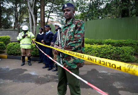 Policemen stand in front of a cordon line following a fire which burnt down one dormitory of Moi Girls school in Nairobi, Kenya September 2, 2017. REUTERS/Baz Ratner