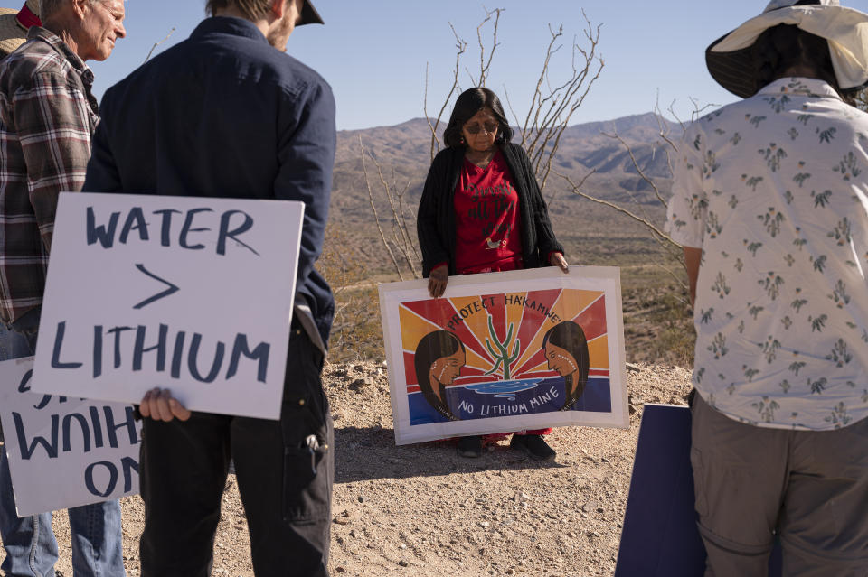 Former Hualapai tribal leader Carrie Imus holds a sign as demonstrators walk though the desert during a rally against the Hawkstone Mining Big Sandy Lithium Project in Wikieup, Ariz., on Dec. 4, 2021. Demonstrators believe that the mine poses a threat to the water supply during an ongoing severe drought.<span class="copyright">Bridget Bennett—Bloomberg/Getty Images</span>