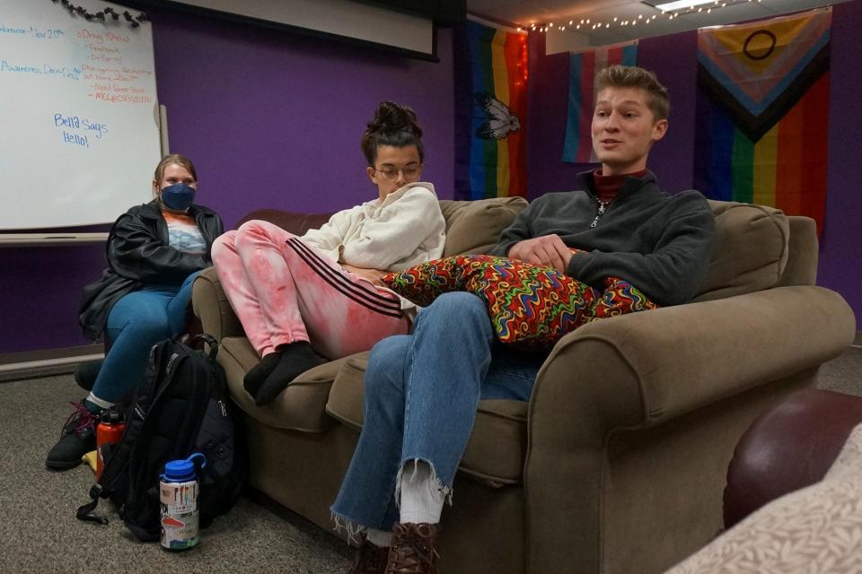 Ryan Imm, Sean Fisher and Sam Schug (from right to left) sit in the dedicated lounge of QPLUS, the LGBTQ student organization for the College of Saint Benedict and Saint John's University for which they serve as coordinators, on the college's campus in St. Joseph, Minn., on Tuesday, Nov. 8, 2022. The three students say they are encouraged by the Catholic institutions' efforts to affirm LGBTQ students like them, such as making QPLUS an official, funded organization from the student club it previously was. (AP Photo/Giovanna Dell'Orto)