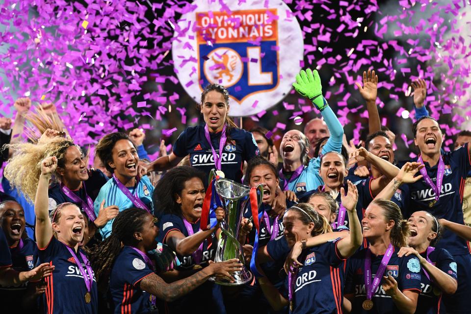 Last season’s Champions League winners Lyon celebrate with the trophy (Getty)