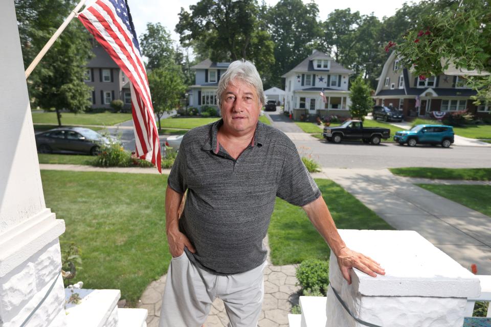 Ron Gaca of Lancaster, a Buffalo suburb, spends much of his time on the front porch. He wants to go back to work pouring concrete but his lingering Covid-19 ailments include fatigue and tremors in his right arm and hand.