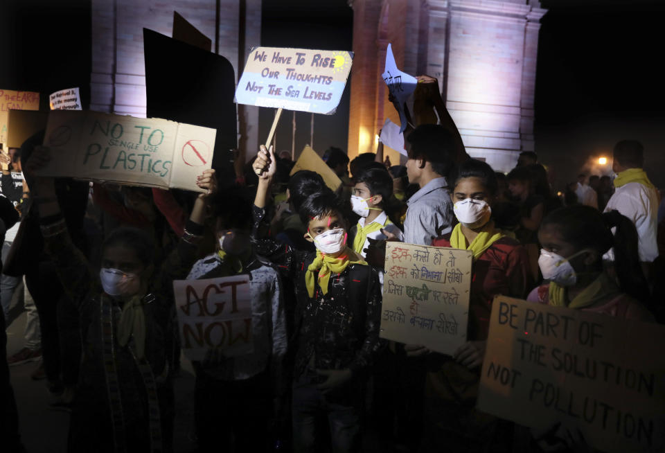 Children wear masks and hold placards during a protest against the alarming levels of pollution in the city, near the India Gate monument in New Delhi, India, Tuesday, Nov. 5, 2019. The 20 million residents of New Delhi, already one of the world's most polluted cities, have been suffering for weeks under a toxic haze that is up to 10 times worse than the upper limits of what is considered healthy. The pollution crisis is piling public pressure on the government to tackle the root causes of the persistent haze. (AP Photo/Manish Swarup)