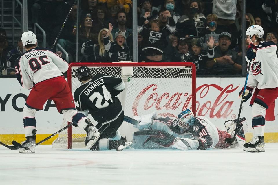 Los Angeles Kings center Phillip Danault (24) scores against Columbus Blue Jackets goaltender Elvis Merzlikins (90) during the first period of an NHL hockey game Saturday, April 16, 2022, in Los Angeles. (AP Photo/Ashley Landis)