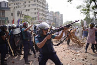 Security officers disperse demonstrators protesting against the visit of Indian Prime Minister Narendra Modi after Friday prayers at Baitul Mokarram mosque in Dhaka, Bangladesh, Friday, March 26, 2021. Witnesses said violent clashes broke out after one faction of protesters began waving their shoes as a sign of disrespect to Indian Prime Minister Narendra Modi, and another group tried to stop them. Local media said the protesters who tried to stop the shoe-waving are aligned with the ruling Awami League party. The party criticized the other protest faction for attempting to create chaos in the country during Modi’s visit. (AP Photo/Mahmud Hossain Opu)