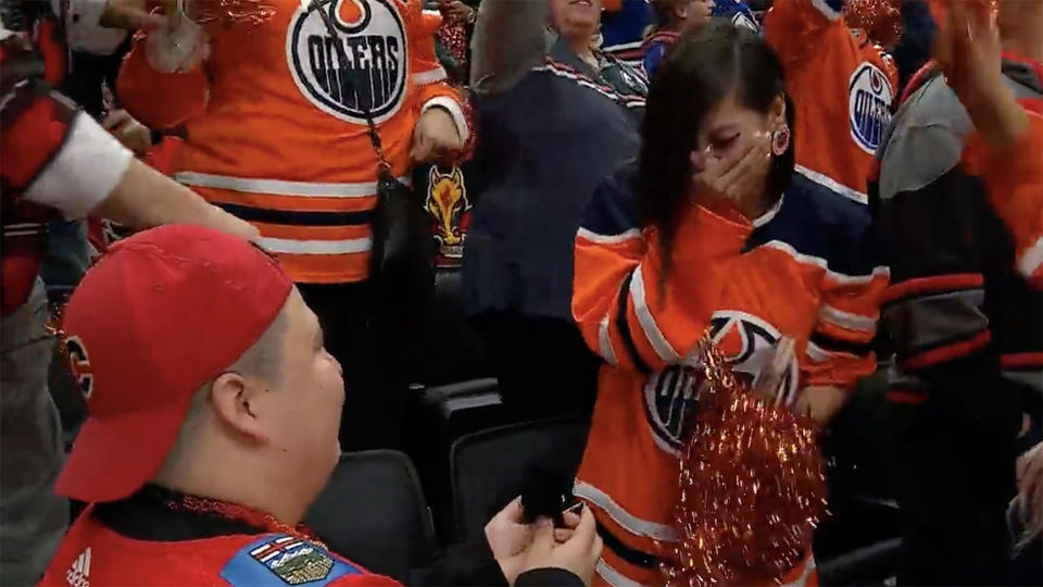 The Oilers and Flames' rivalry couldn't get in the way of their love. (Screen shot via @timandfriends/Twitter)