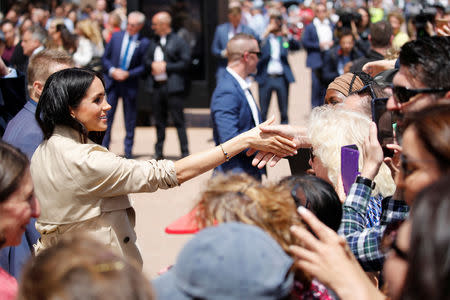 Britain's Meghan, Duchess of Sussex shakes hands with a member of the public during a visit at the Sydney Opera House in Sydney, Australia October 16, 2018. REUTERS/Phil Noble