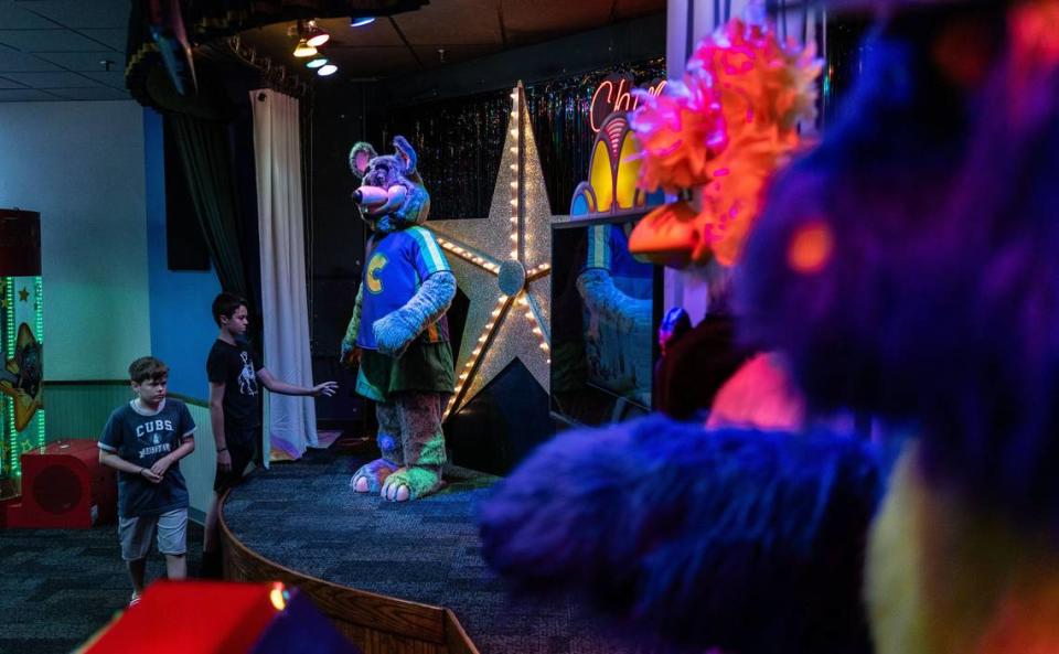 Oliver Zepsa, 14, back, and his brother, Dominic, 12, look at Munch’s Make Believe Band at Chuck E. Cheese in Charlotte. Oliver and Dominic are animatronics enthusiasts and came to see the band once they heard the news that this location would be keeping them.