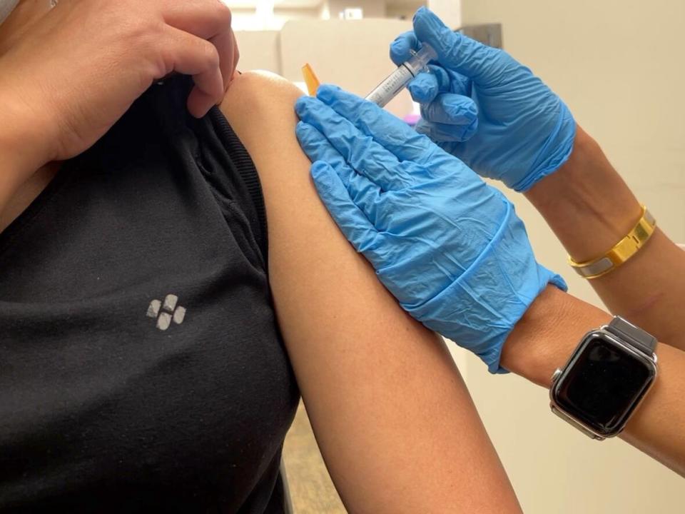 A pharmacist is seen administering a flu shot. Most pharmacists, family physicians and nurse practitioners will be able to administer the vaccine starting Monday.  (Emily Fitzpatrick/CBCNEWS - image credit)