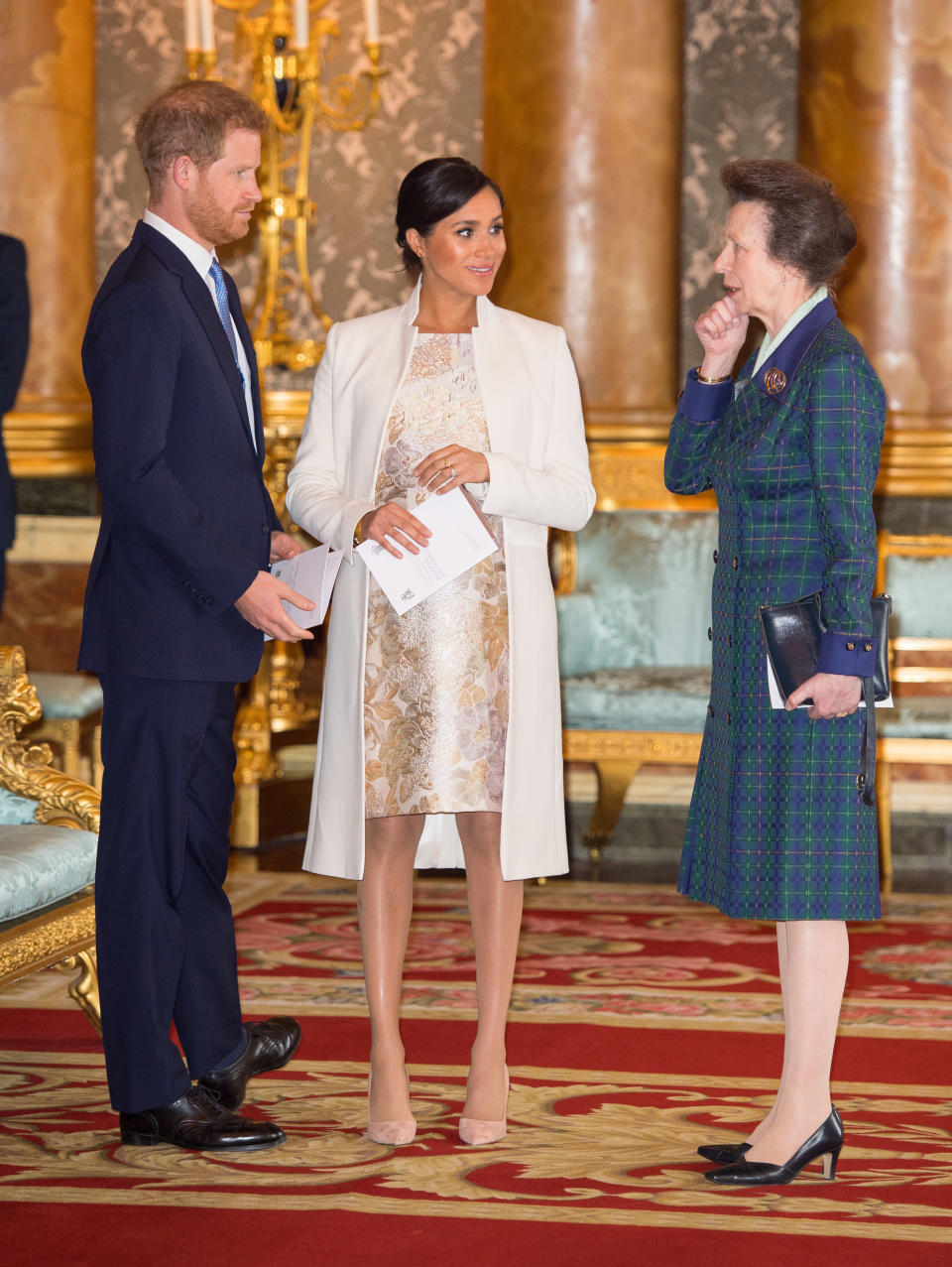 Britain's Prince Harry, Duke of Sussex, (L) and Britain's Meghan, Duchess of Sussex (C) and Britain's Princess Anne, Princess Royal, (R) attend a reception to mark the 50th Anniversary of the investiture of The Prince of Wales at Buckingham Palace in London on March 5, 2019. - The Queen hosted a reception to mark the Fiftieth Anniversary of the investiture of Britain's Prince Charles, her son, as the Prince of Wales. Prince Charles was created The Prince of Wales aged 9 on July 26th 1958 and was formally invested with the title by Her Majesty The Queen on July 1st 1969 at Caernarfon Castle. (Photo by Dominic Lipinski / POOL / AFP)        (Photo credit should read DOMINIC LIPINSKI/AFP via Getty Images)