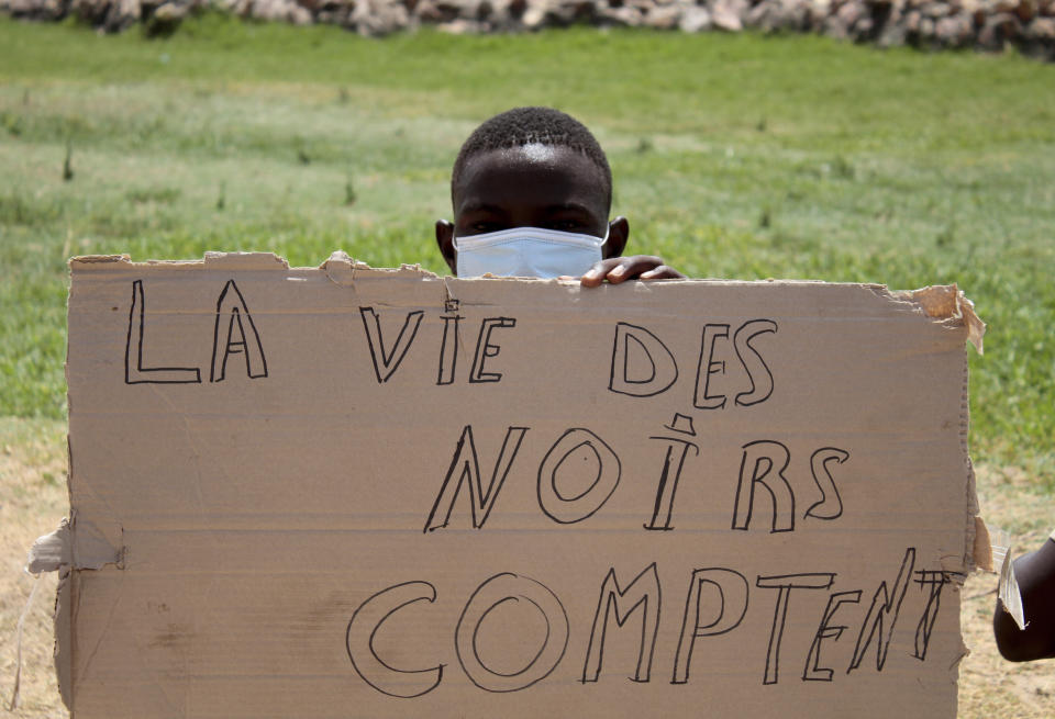 A migrant holds a placard reading "Black Lives Matter" during a gathering in Sfax, Tunisia's eastern coast, Friday, July 7, 2023. Tensions spiked dangerously in a Tunisian port city this week after three migrants were detained in the death of a local man, and there were reports of retaliation against Black foreigners and accounts of mass expulsions and alleged assaults by security forces. (AP Photo)